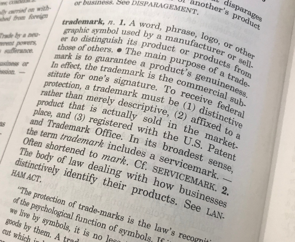 Trademark - Dictionary page - A word, phrase, logo, or other graphic symbol used by a manufacturer or seller to distinguish its product or products from those of others.